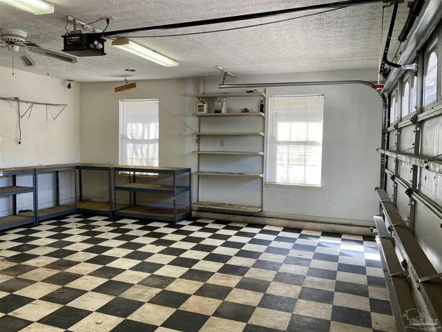 a room with lots of wooden cabinets and a rug