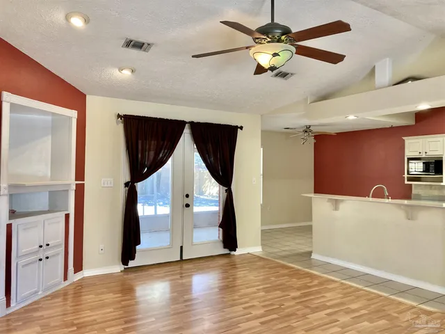 a view of an entryway with wooden floor
