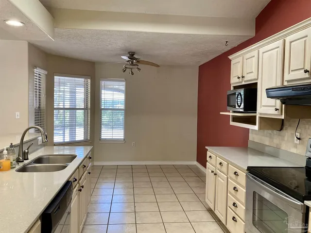 a kitchen with a sink stove and cabinets