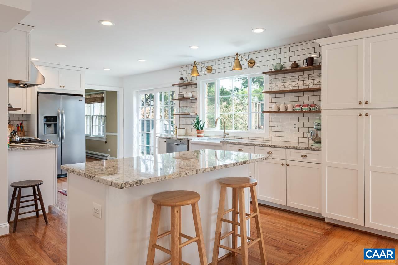 2500 South Bennington Road Charlottesville, VA 22901 - Photo 5 of 33 a kitchen with stainless steel appliances granite countertop a table chairs and a refrigerator