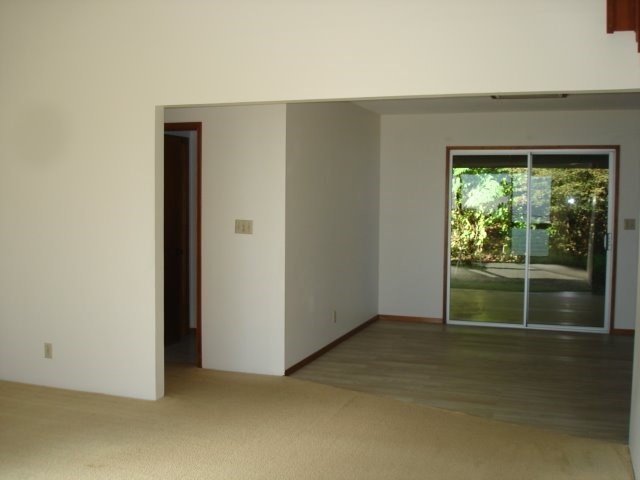 2215 Kaiwiki Road Hilo, HI 96720 - Photo 11 of 30 an empty room with wooden floor and windows