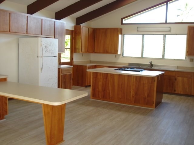 2215 Kaiwiki Road Hilo, HI 96720 - Photo 12 of 30 a kitchen with stainless steel appliances granite countertop a sink a stove a refrigerator a center island and a window