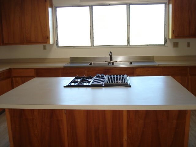2215 Kaiwiki Road Hilo, HI 96720 - Photo 13 of 30 a kitchen with a sink a window and cabinets