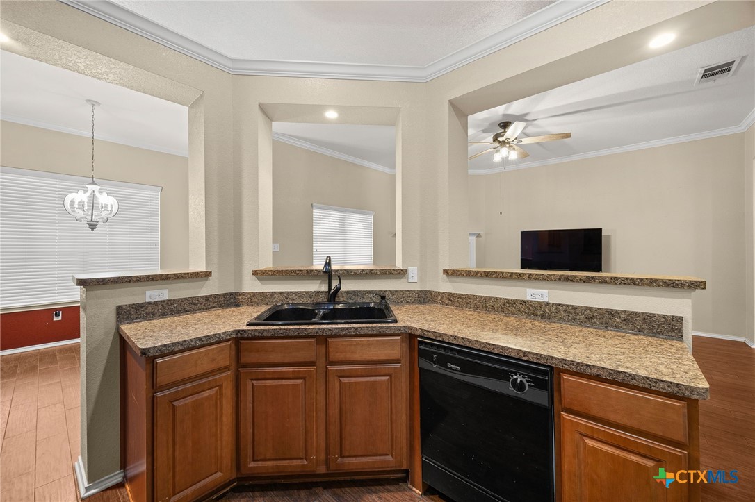 910 Neuberry Cliffe Temple, TX 76502 - Photo 11 of 32 a kitchen with a sink and a refrigerator