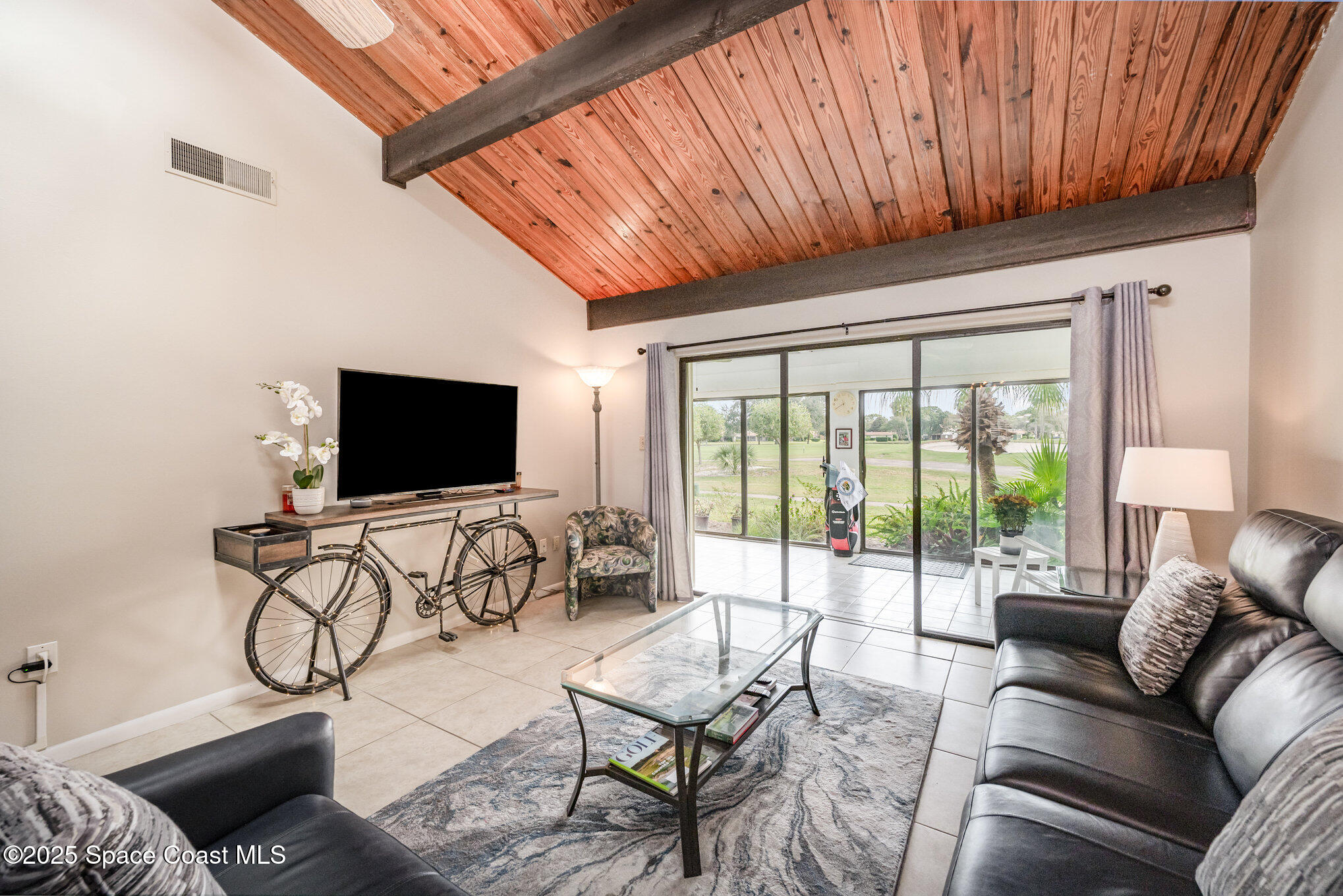 197 Augusta Way Melbourne, FL 32940 - Photo 12 of 37 a living room with furniture and a flat screen tv