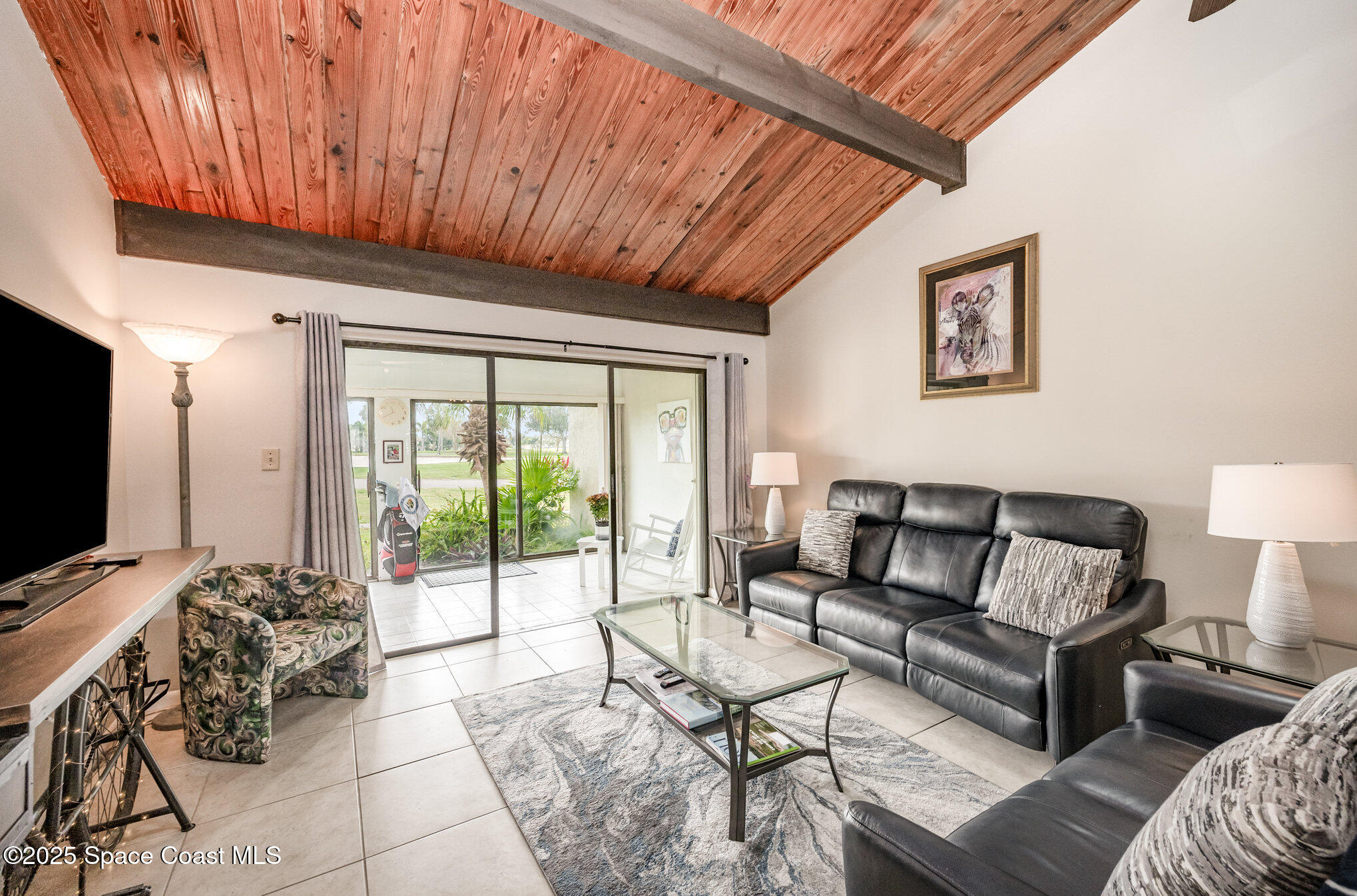 197 Augusta Way Melbourne, FL 32940 - Photo 13 of 37 a living room with furniture and a flat screen tv