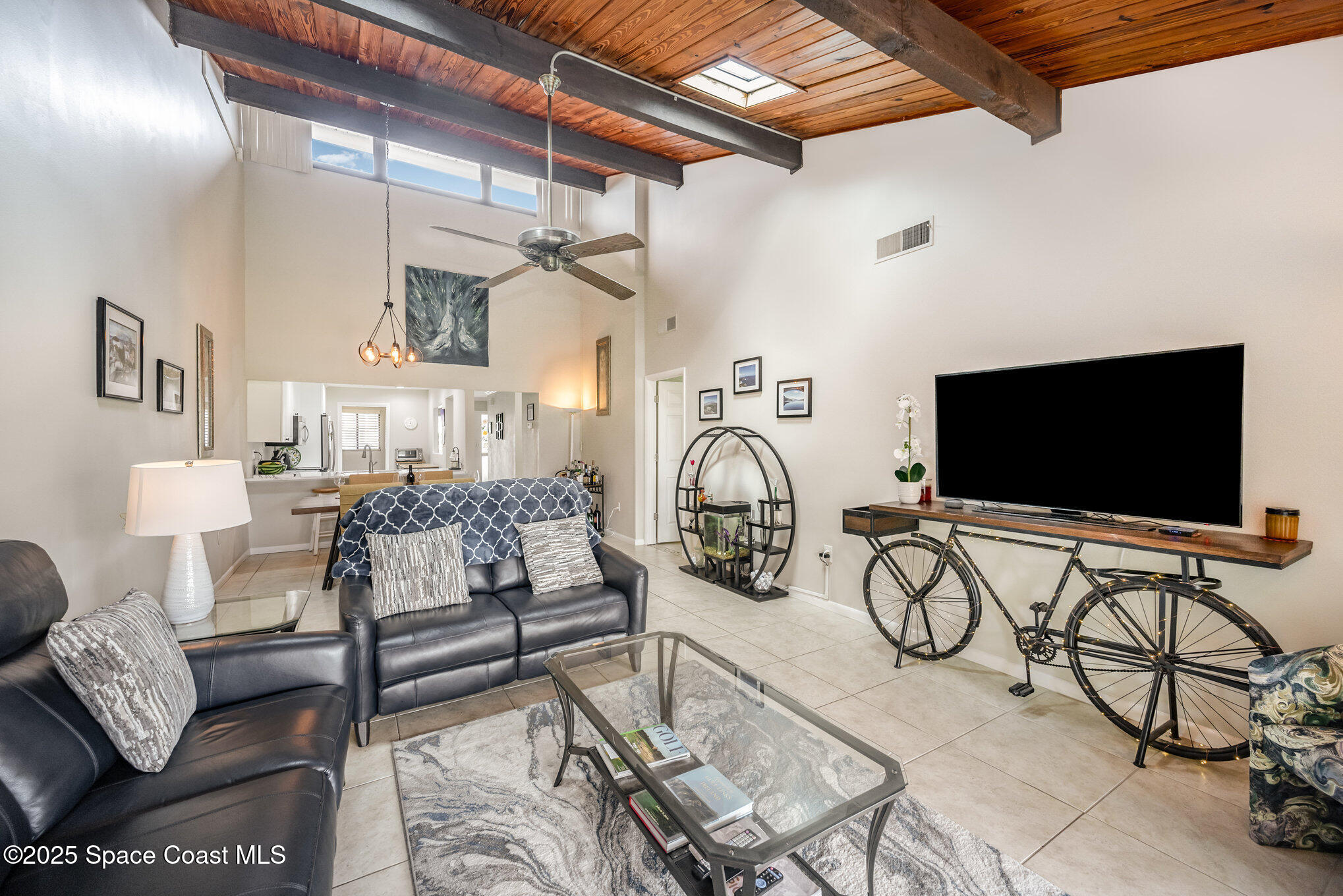 197 Augusta Way Melbourne, FL 32940 - Photo 14 of 37 a view of a livingroom with furniture and a flat screen tv
