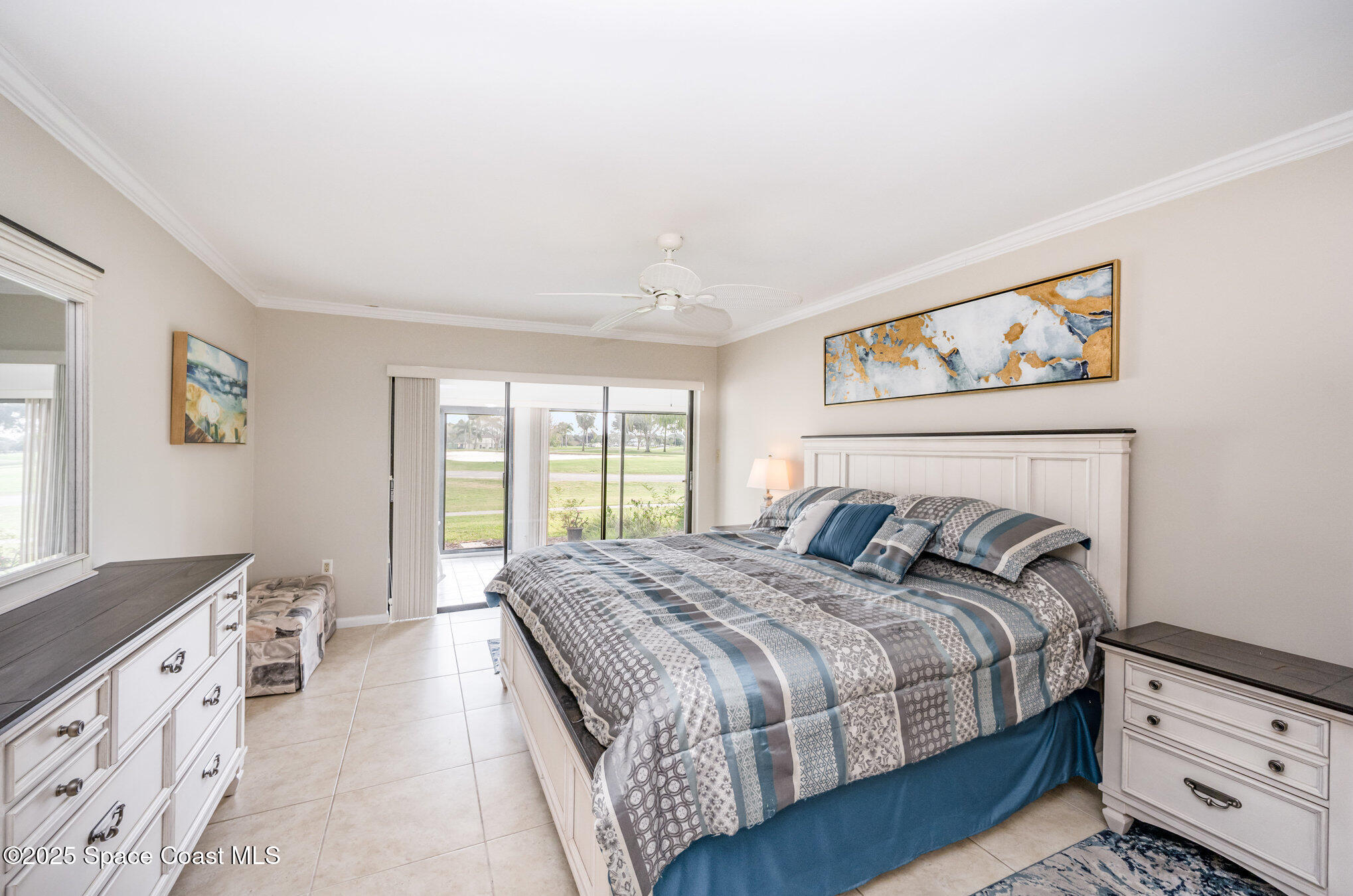 197 Augusta Way Melbourne, FL 32940 - Photo 16 of 37 a bedroom with a bed and a cabinets