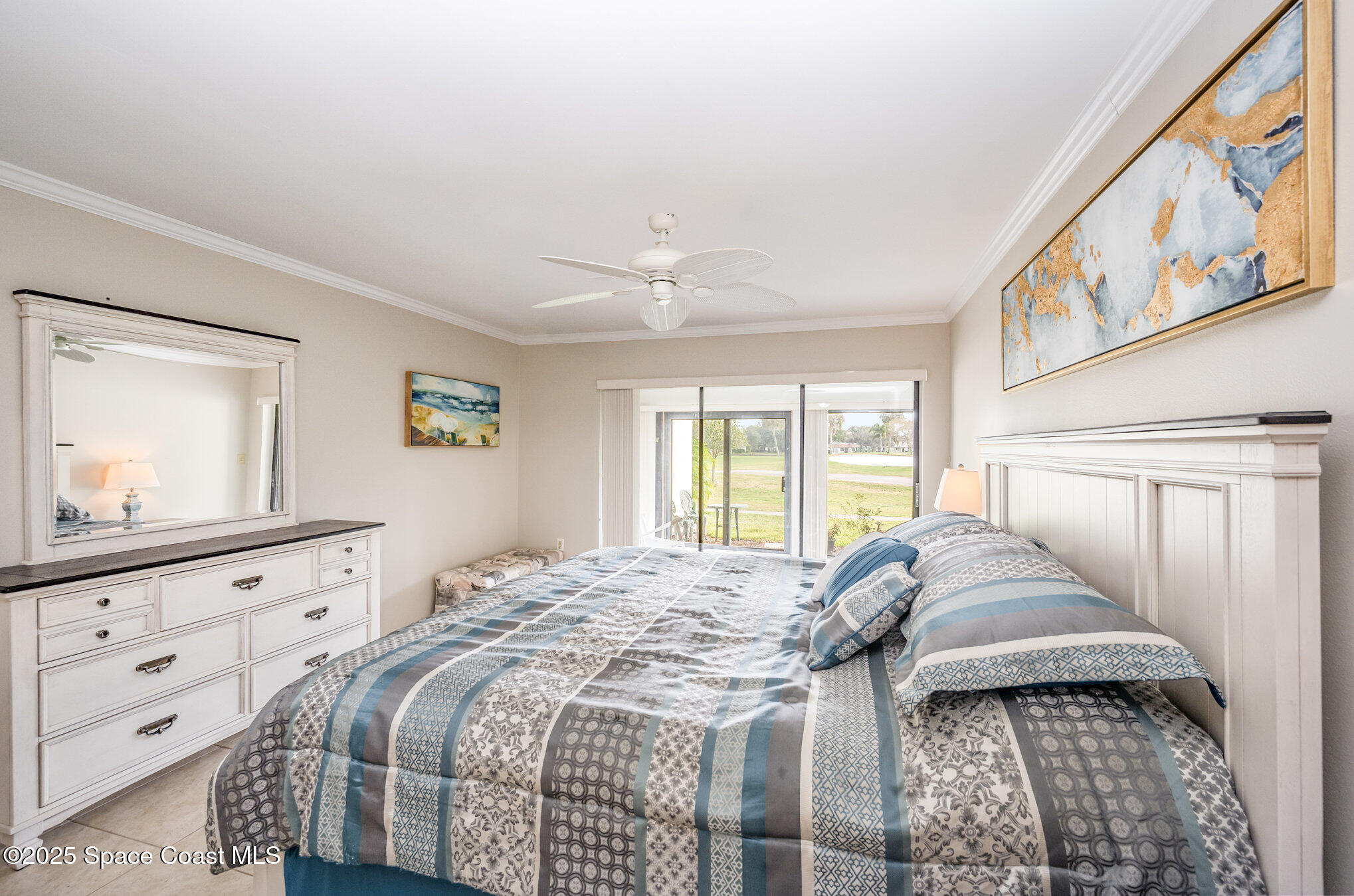 197 Augusta Way Melbourne, FL 32940 - Photo 17 of 37 a bedroom with a bed and a window