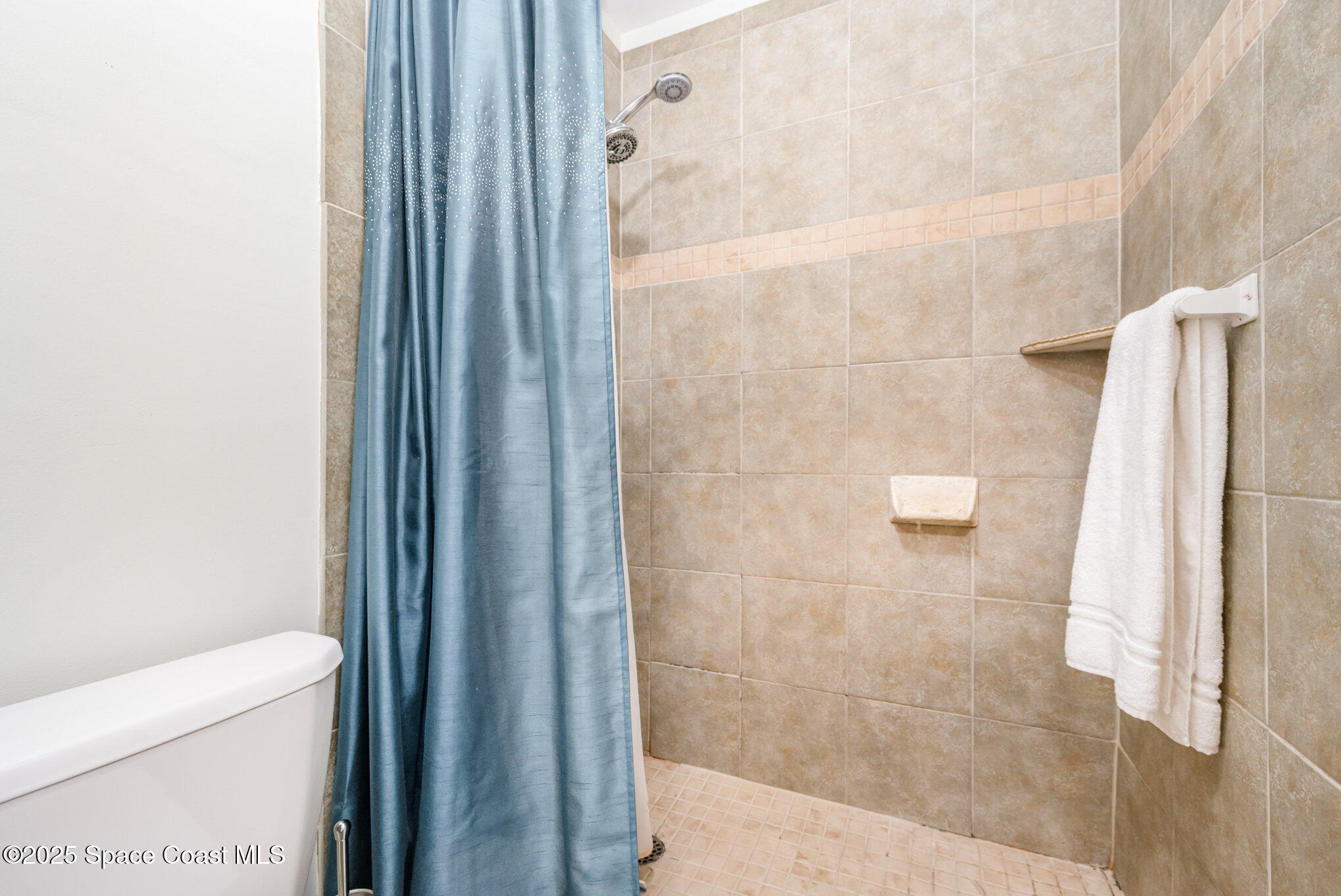 197 Augusta Way Melbourne, FL 32940 - Photo 19 of 37 a bathroom with a shower and a toilet