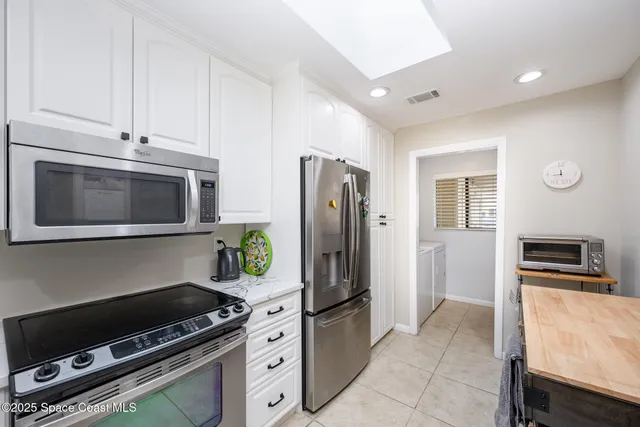 a kitchen with stainless steel appliances a stove a microwave and a refrigerator