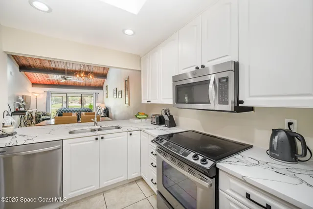 a kitchen with a sink and a stove top oven