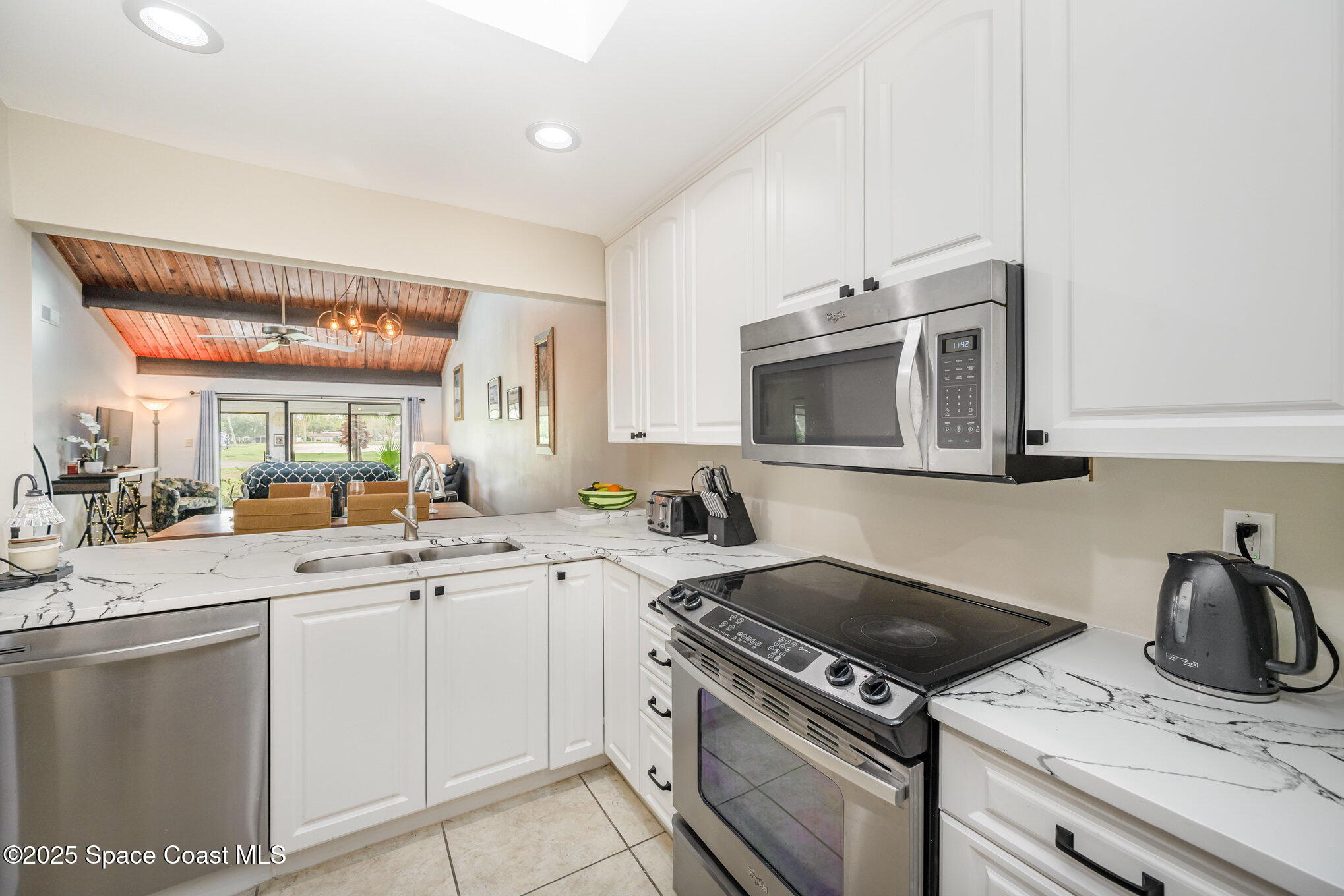197 Augusta Way Melbourne, FL 32940 - Photo 8 of 37 a kitchen with a sink and a stove top oven