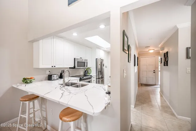a kitchen with a sink refrigerator and cabinets