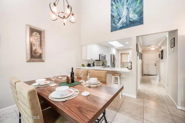 a dining room with furniture and a kitchen view