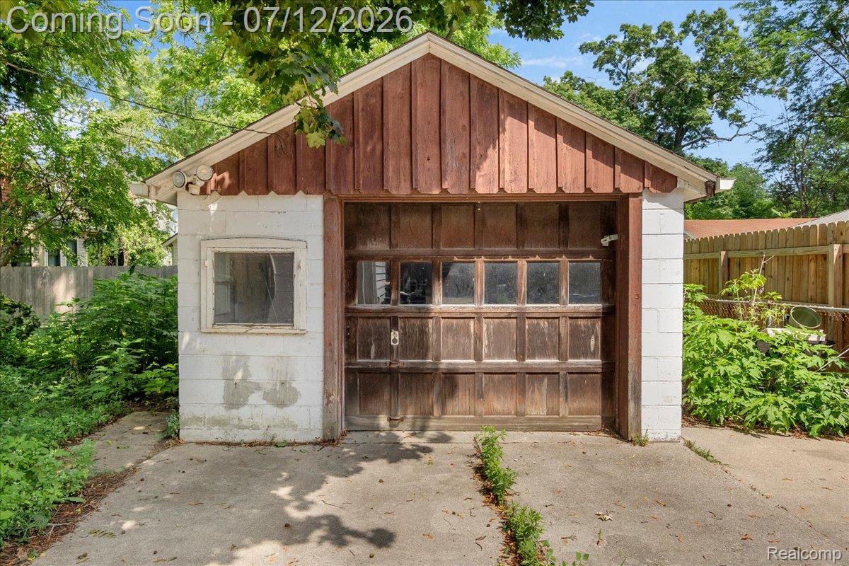 624 North Prospect Road Ypsilanti, MI 48198 - Photo 24 of 28 Detached garage with a paneled wood overhead door and single-pane window