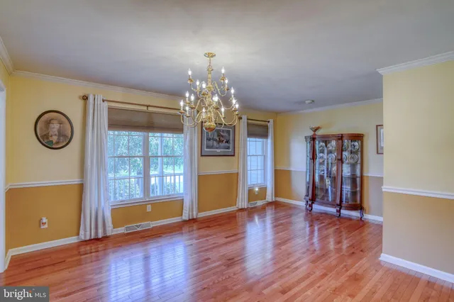 a view of a room with wooden floor and window
