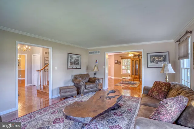 a living room with furniture wooden floor and window