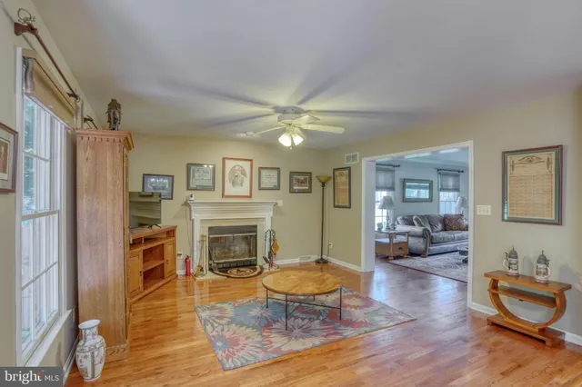 a living room with fireplace furniture and a flat screen tv