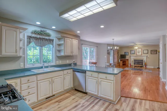 a kitchen with granite countertop a refrigerator and cabinets