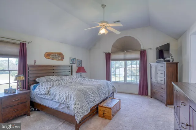 a bedroom with a bed and a dresser with mirror