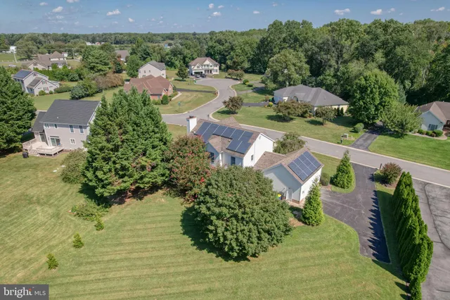 an aerial view of a house with yard