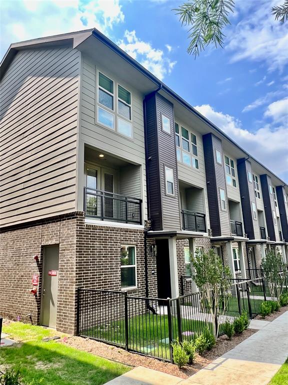 4020 McEwen Road, Unit 4107 Farmers Branch, TX 75244 - Photo 1 of 1 a front view of a house with a garden
