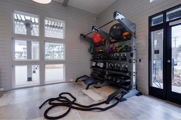 a room with gym equipment and a large window