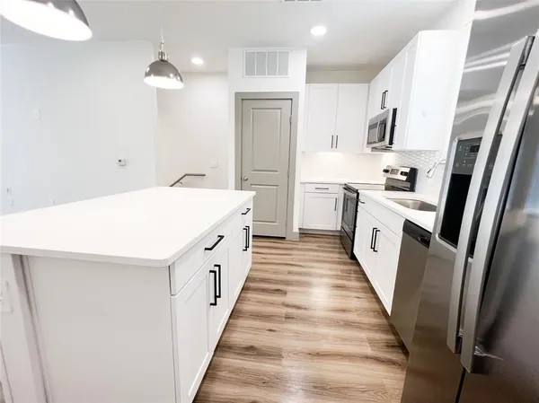 a utility room with cabinets washer and dryer