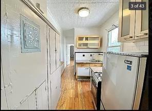 256 Withers Street Brooklyn, NY 11211 - Photo 2 of 14 a kitchen with stainless steel appliances granite countertop a refrigerator and a stove