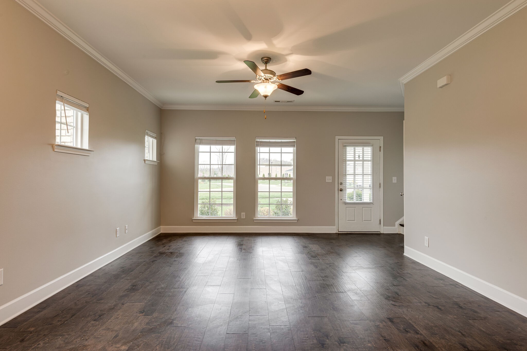 269 Mary Ann Circle Spring Hill, TN 37174 - Photo 5 of 28 a view of an empty room with wooden floor and a window