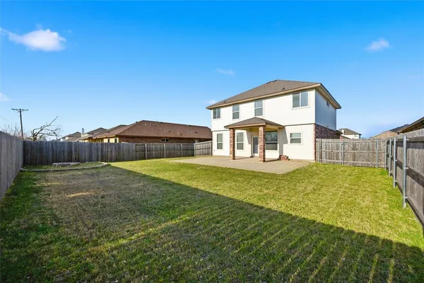 a house view with swimming pool in front of it