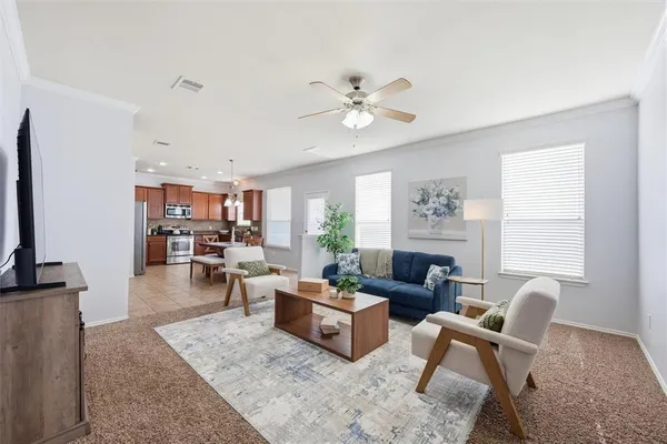 a living room with furniture wooden floor and a window