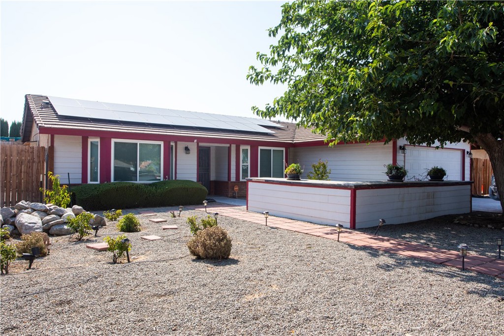 11957 Wapato Road Apple Valley, CA 92308 - Photo 1 of 1 a view of house with yard outdoor seating and covered with furniture