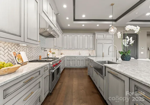 a spacious bedroom with a large bed and a chandelier