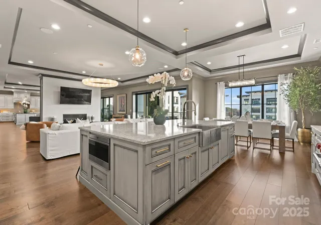 a spacious bedroom with a large bed and a chandelier
