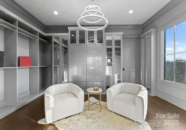 a bedroom with a large bed and a chandelier