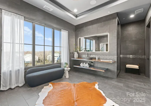 a bathroom with a sink a toilet a shower and a mirror