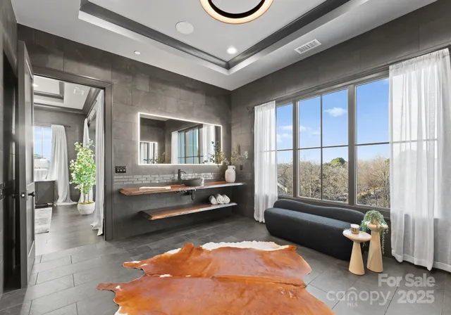 a spacious bedroom with a bed a couch and a window