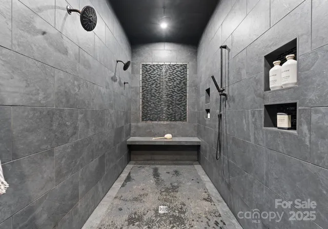 a spacious bathroom with a double vanity sink a mirror a bathtub and shower