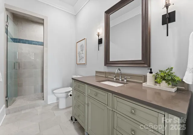 a bath room with a toilet a sink and a mirror
