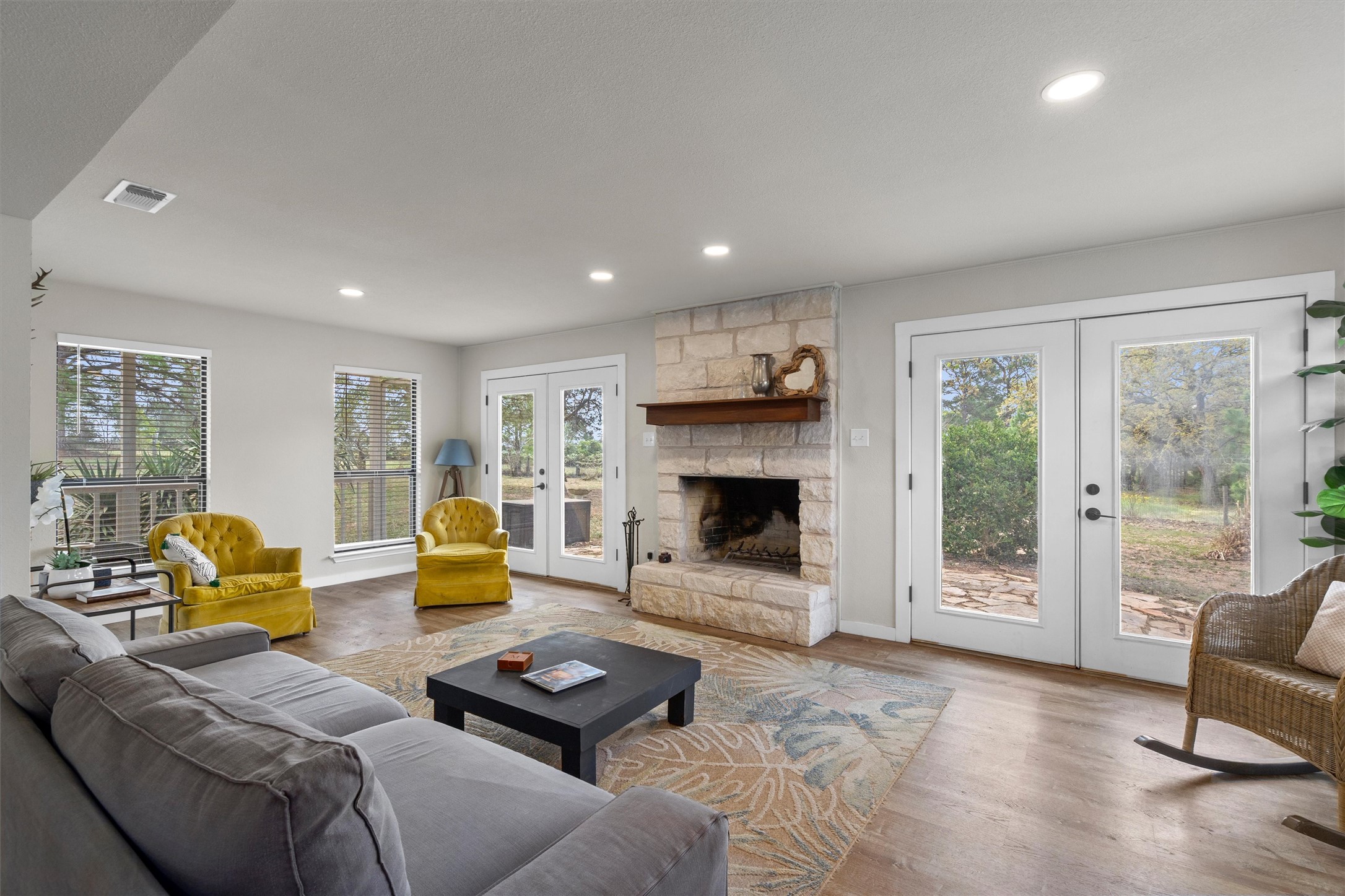 836 Cottle Town Road Smithville, TX 78957 - Photo 11 of 40 Living room featuring french doors, wood finished floors, recessed lighting, and a fireplace