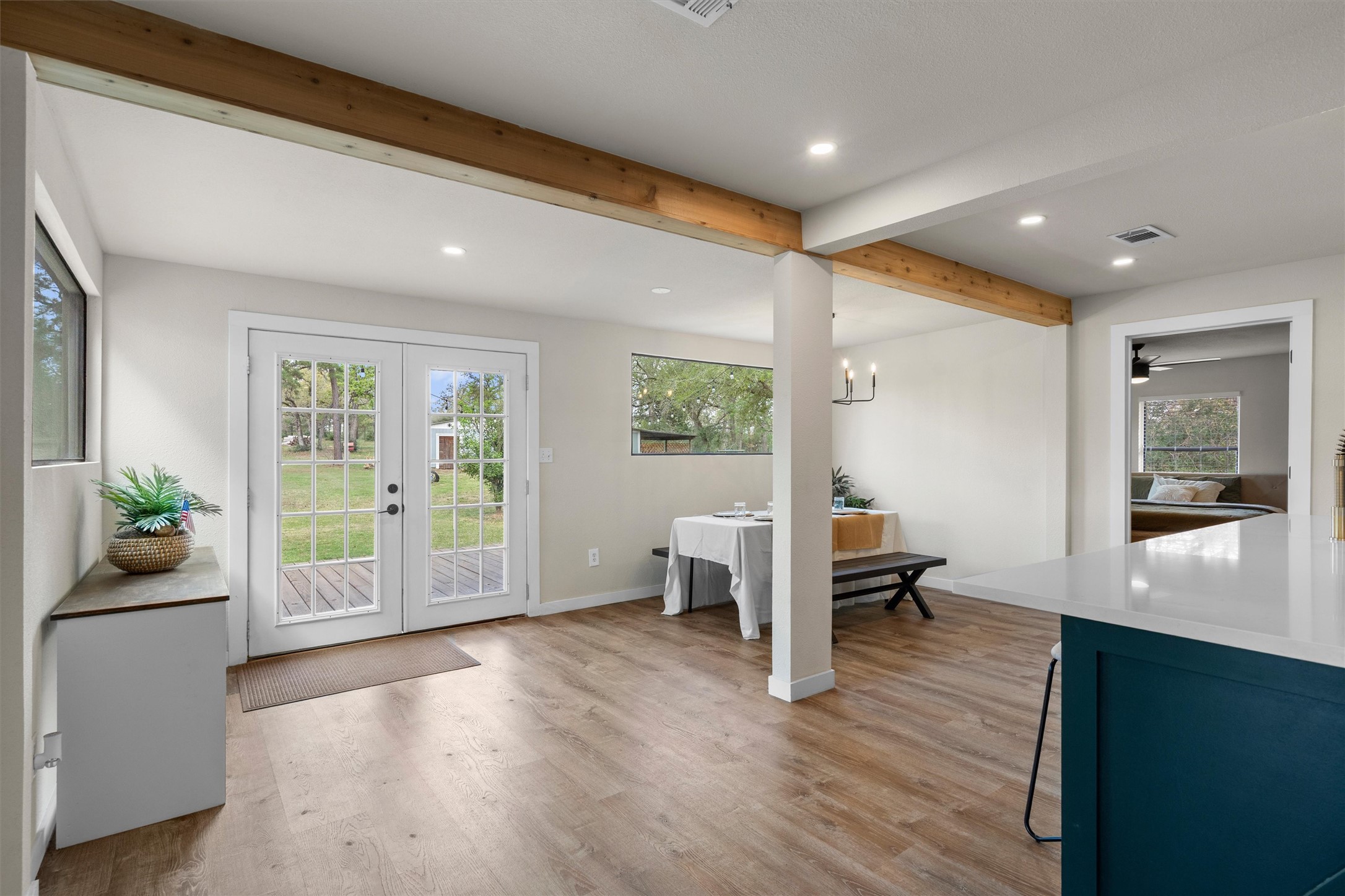 836 Cottle Town Road Smithville, TX 78957 - Photo 14 of 40 Doorway with beamed ceiling, wood finished floors, healthy amount of natural light, recessed lighting, and french doors