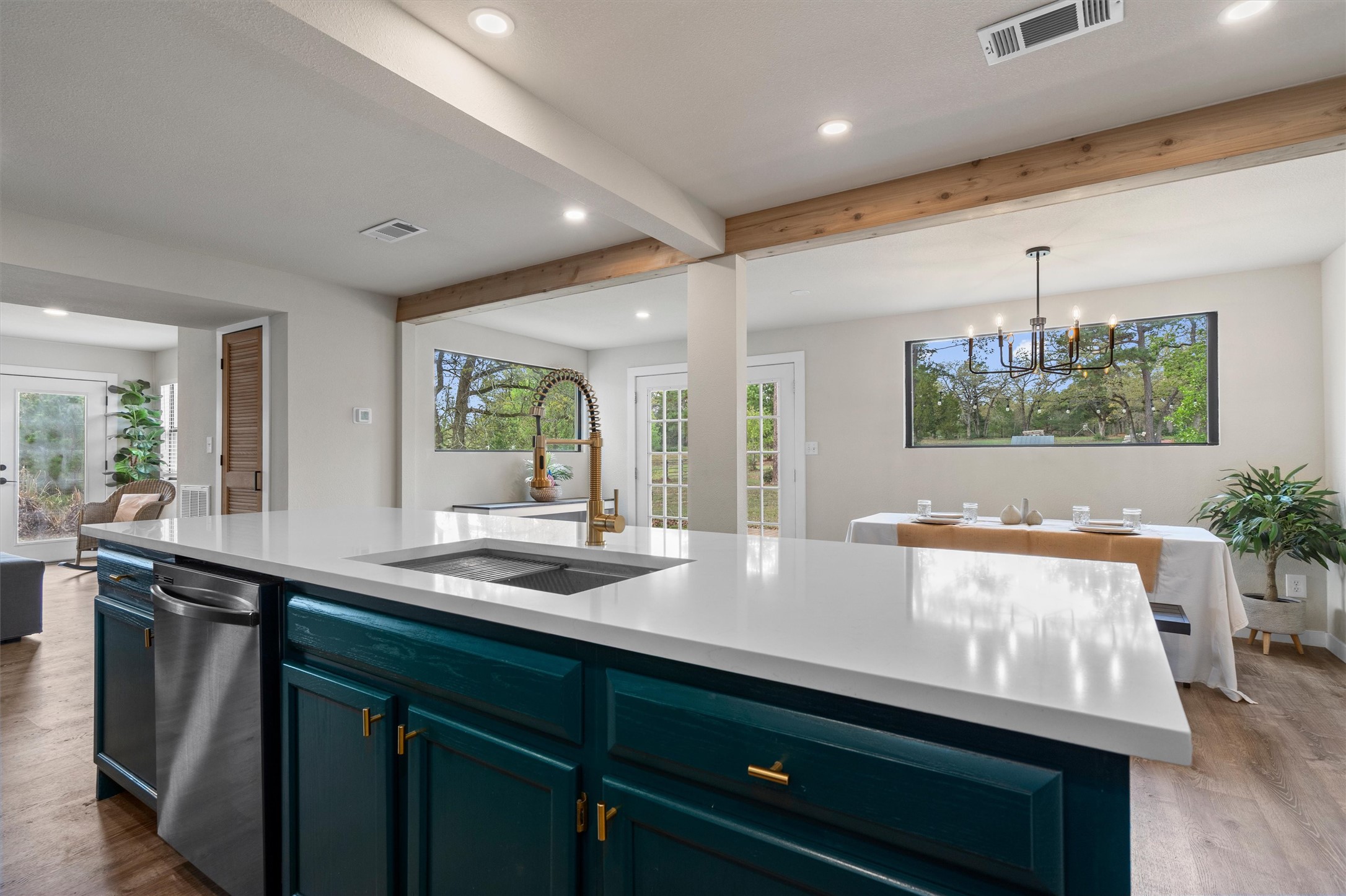 836 Cottle Town Road Smithville, TX 78957 - Photo 38 of 40 Kitchen featuring beamed ceiling, open floor plan, dark wood finished floors, stainless steel dishwasher, and healthy amount of natural light