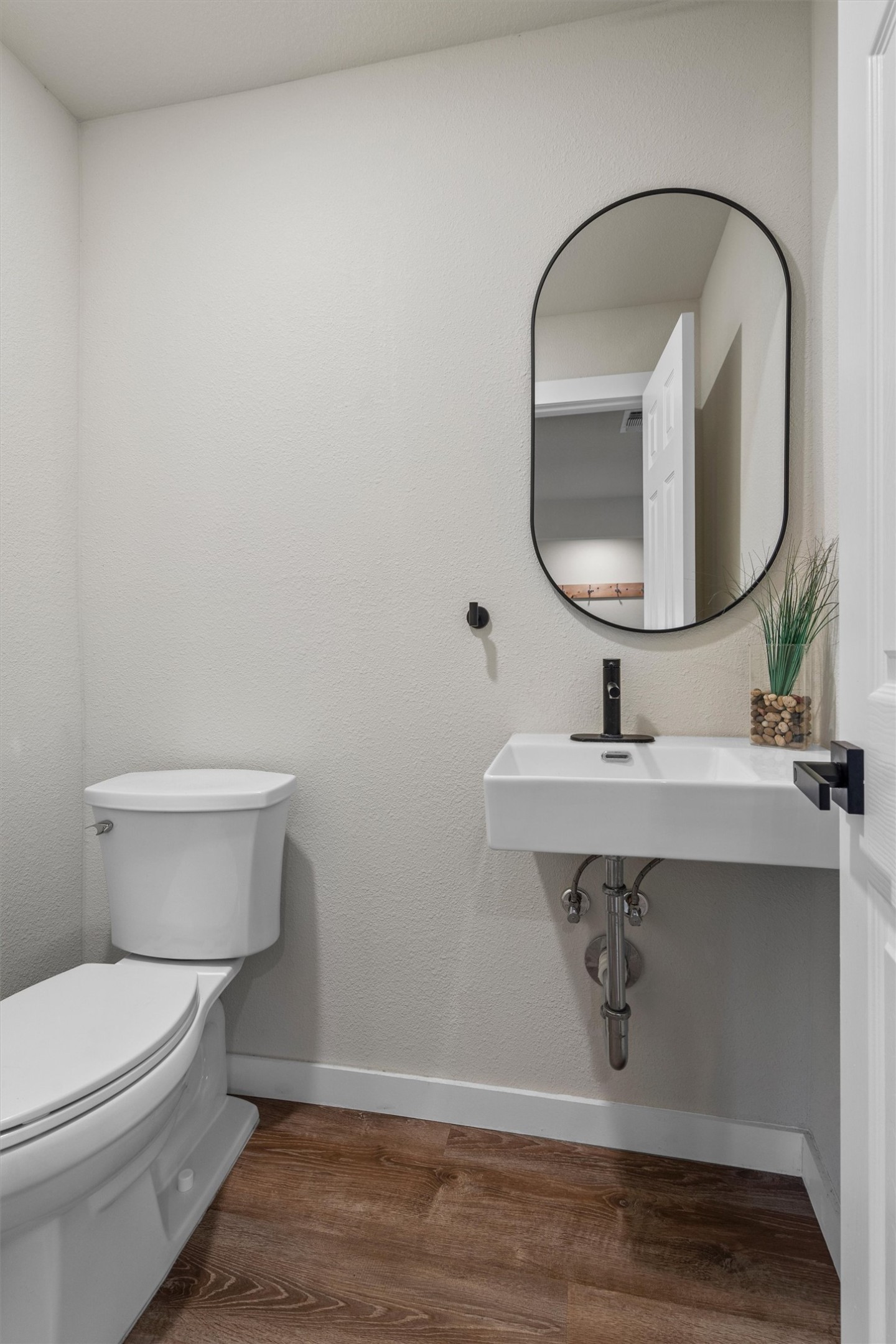836 Cottle Town Road Smithville, TX 78957 - Photo 24 of 40 Half bathroom featuring dark wood-style flooring and toilet