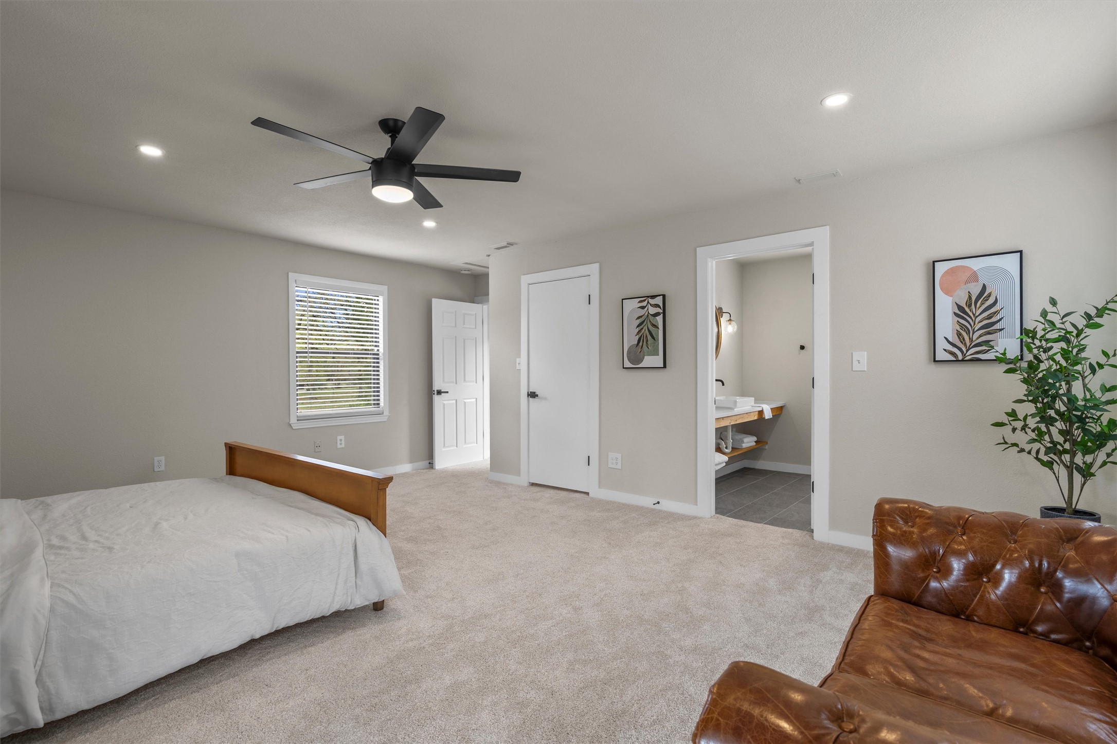 836 Cottle Town Road Smithville, TX 78957 - Photo 26 of 40 Bedroom with light colored carpet, a ceiling fan, recessed lighting, and connected bathroom