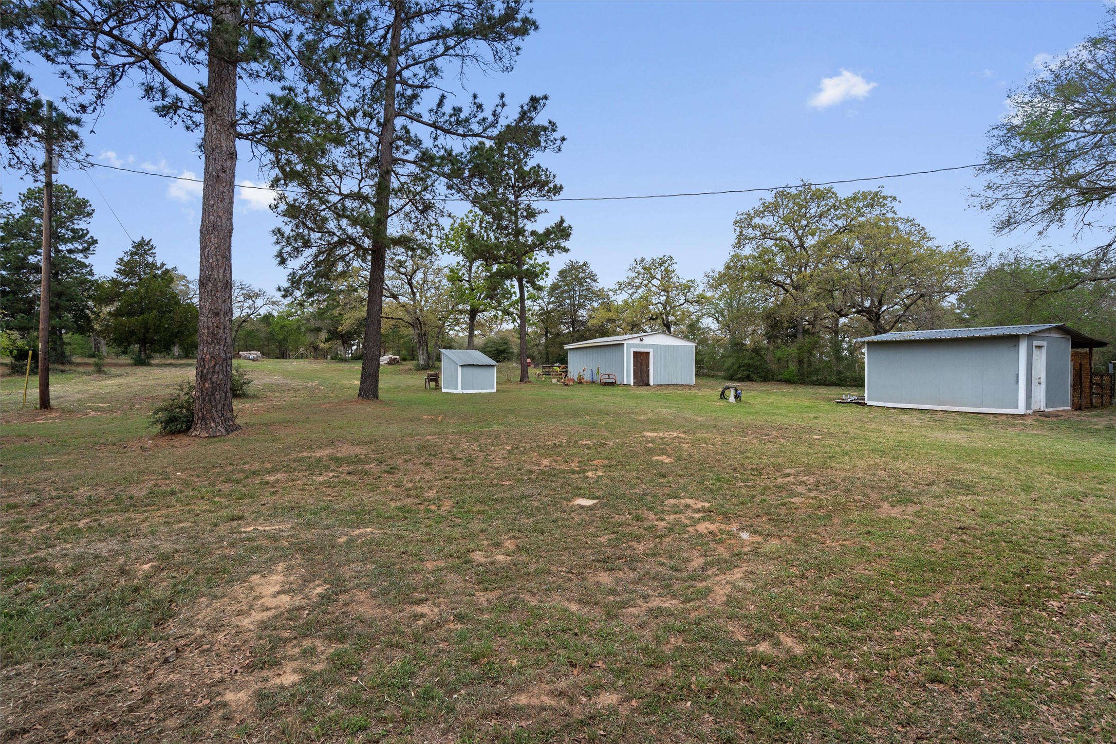836 Cottle Town Road Smithville, TX 78957 - Photo 34 of 40 View of grassy yard featuring a storage unit