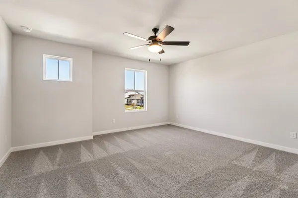 a view of an empty room with a ceiling fan