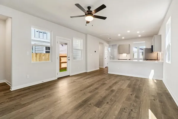a view of a kitchen with wooden floor and a kitchen