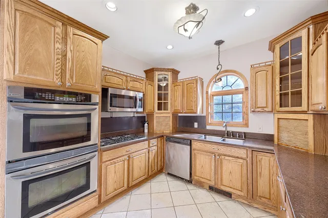 a kitchen with stainless steel appliances granite countertop a stove and a sink